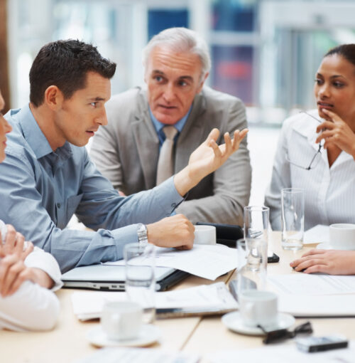 Business meeting - Young man presenting his ideas to colleagues